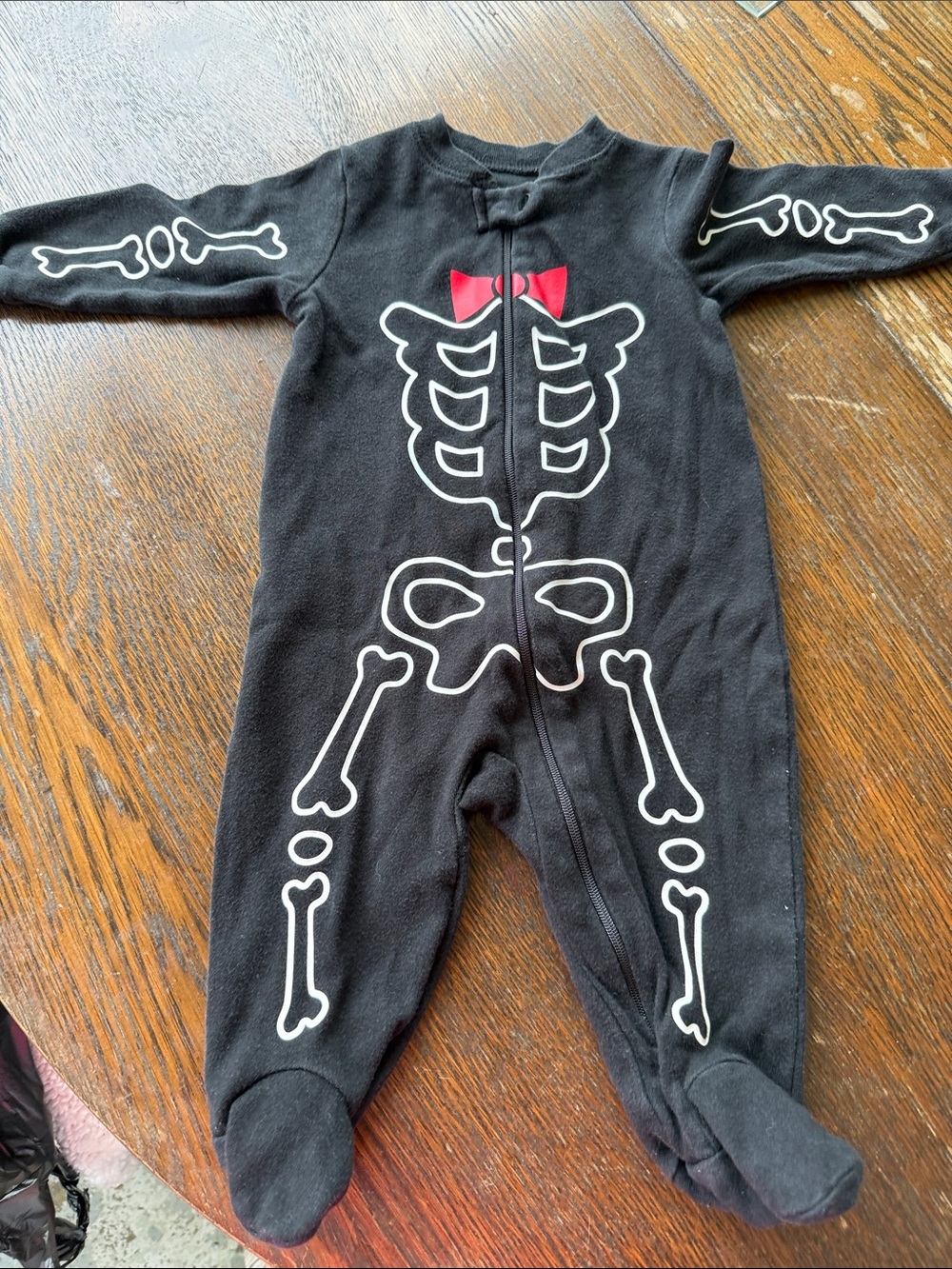 Infant 3-6 mo. Black Skeleton Sleeper with red bow fun for Halloween pre-loved